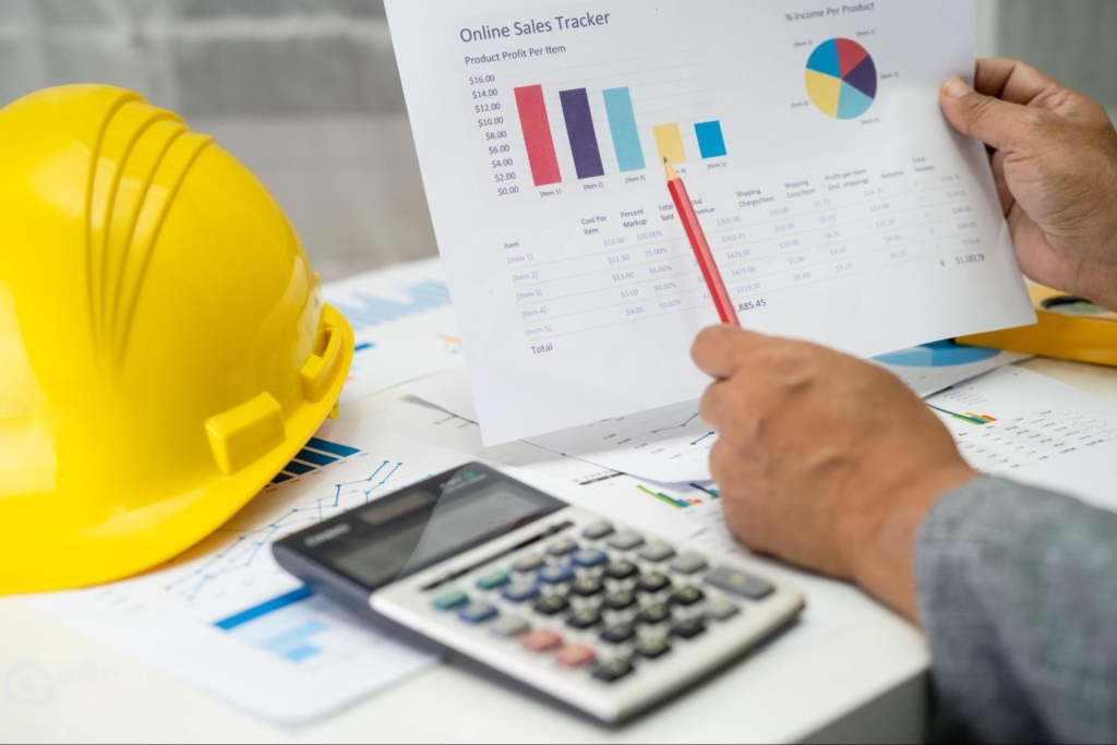 An engineer holding a printed report assessing the construction cost. 