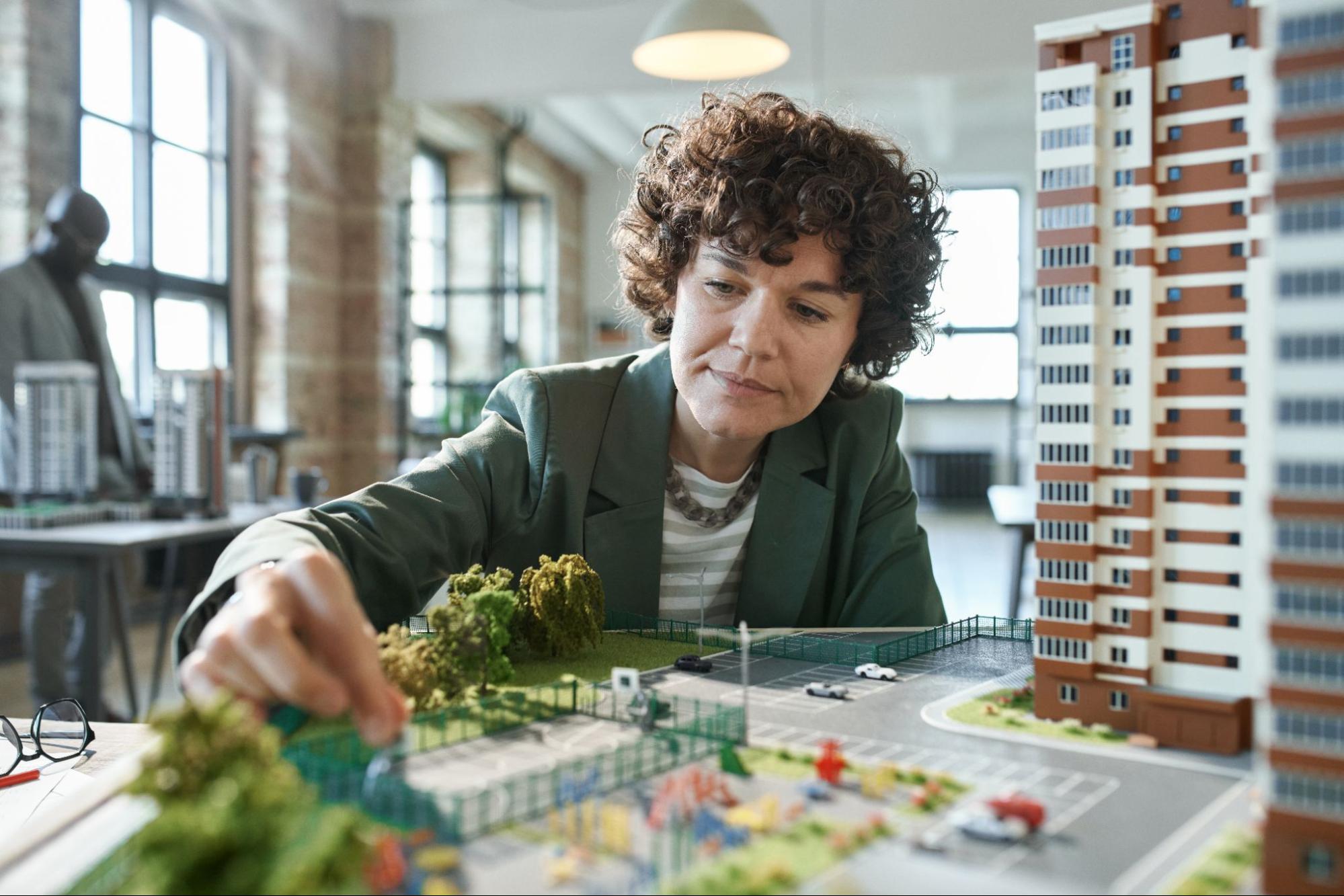 An architect looks through a model layout.