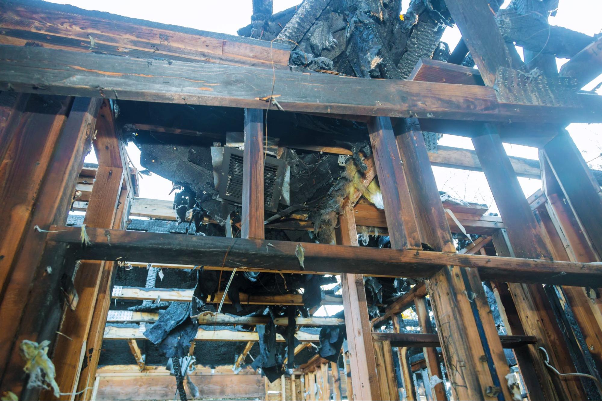 A fire-damaged home with burnt walls.