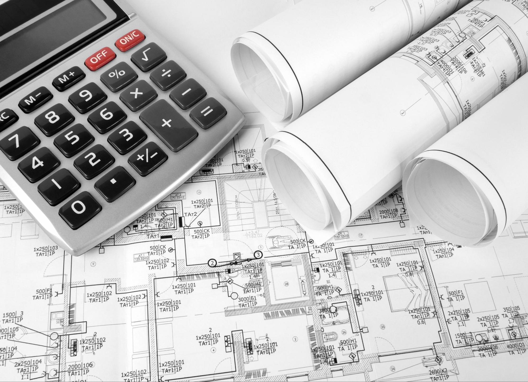 A calculator rests on a blueprint, representing precise cost estimation for successful project execution.